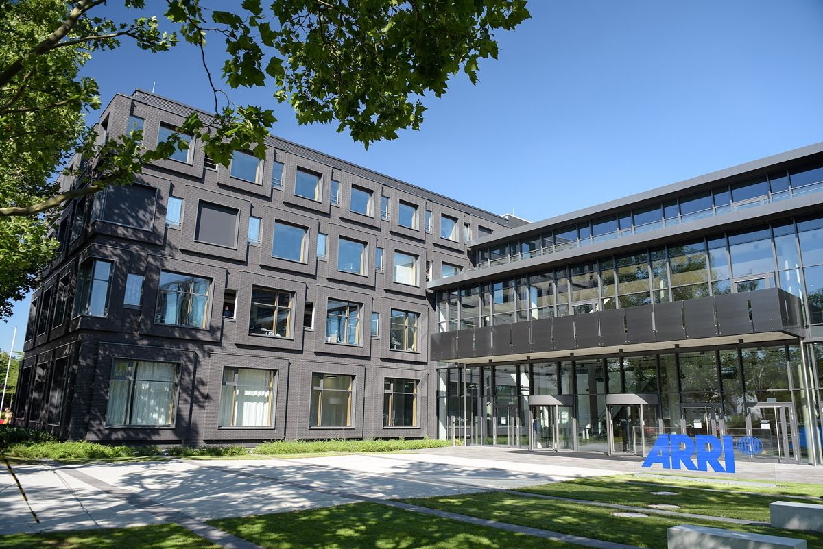 ARRI headquarters ARRIAL in Munich, a dark brick building with a glass entrance wing